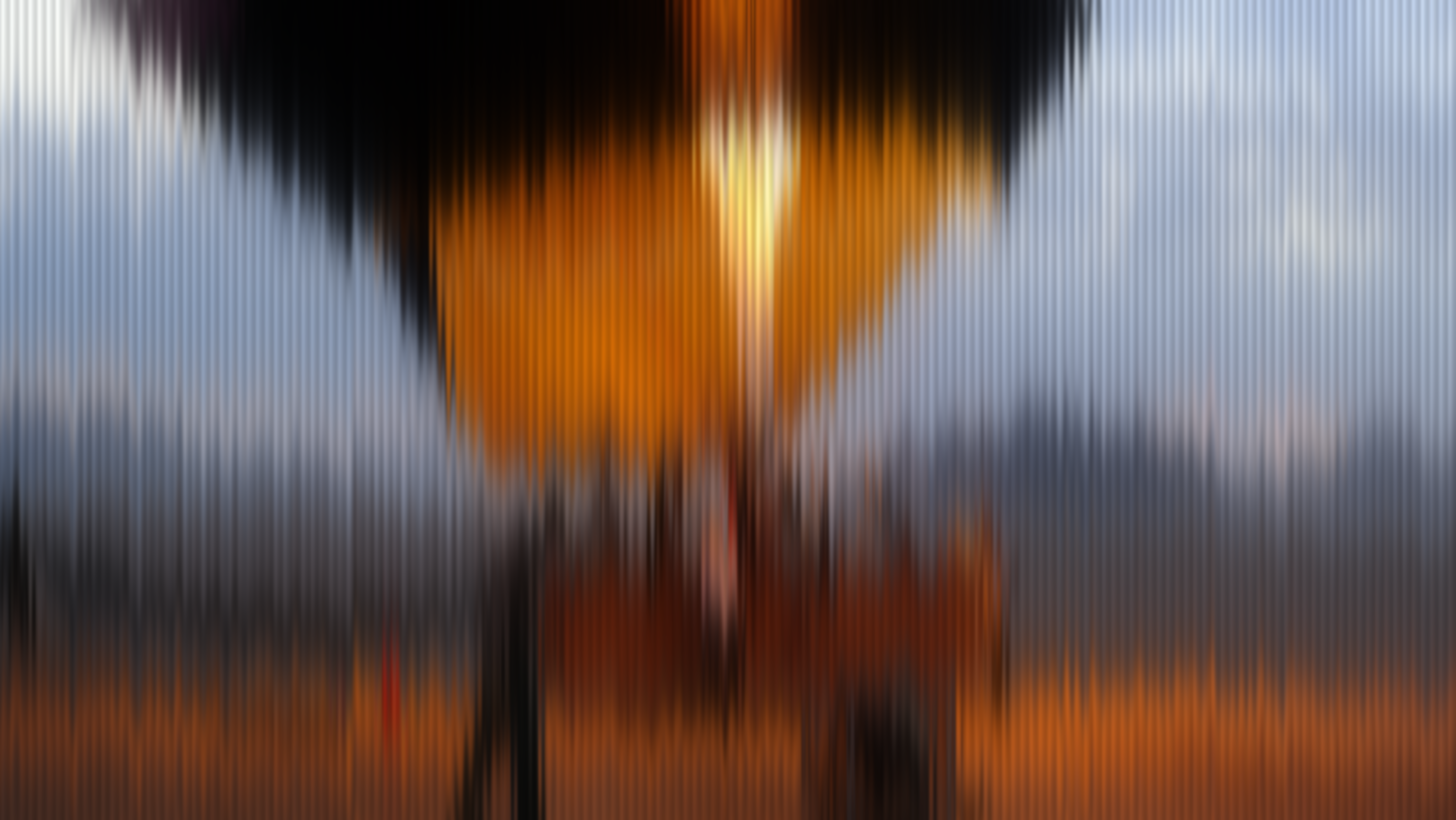 Washed abstract of a warm amber glow under dark clouds